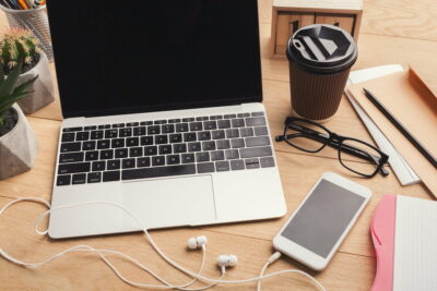 Male workplace with laptop and smartphone