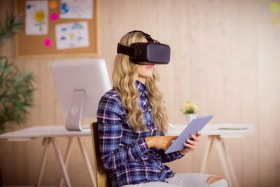 Pretty casual worker using oculus rift in her office