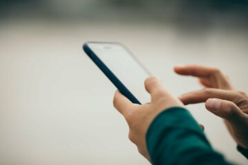 Asian woman using smartphone outdoors