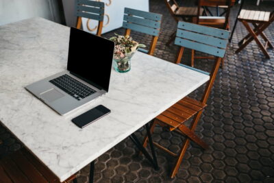 Table with laptop and smartphone in cafeteria