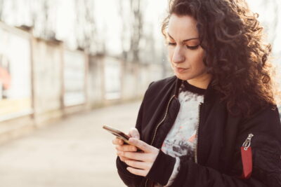 Young woman using smart phone outdoor