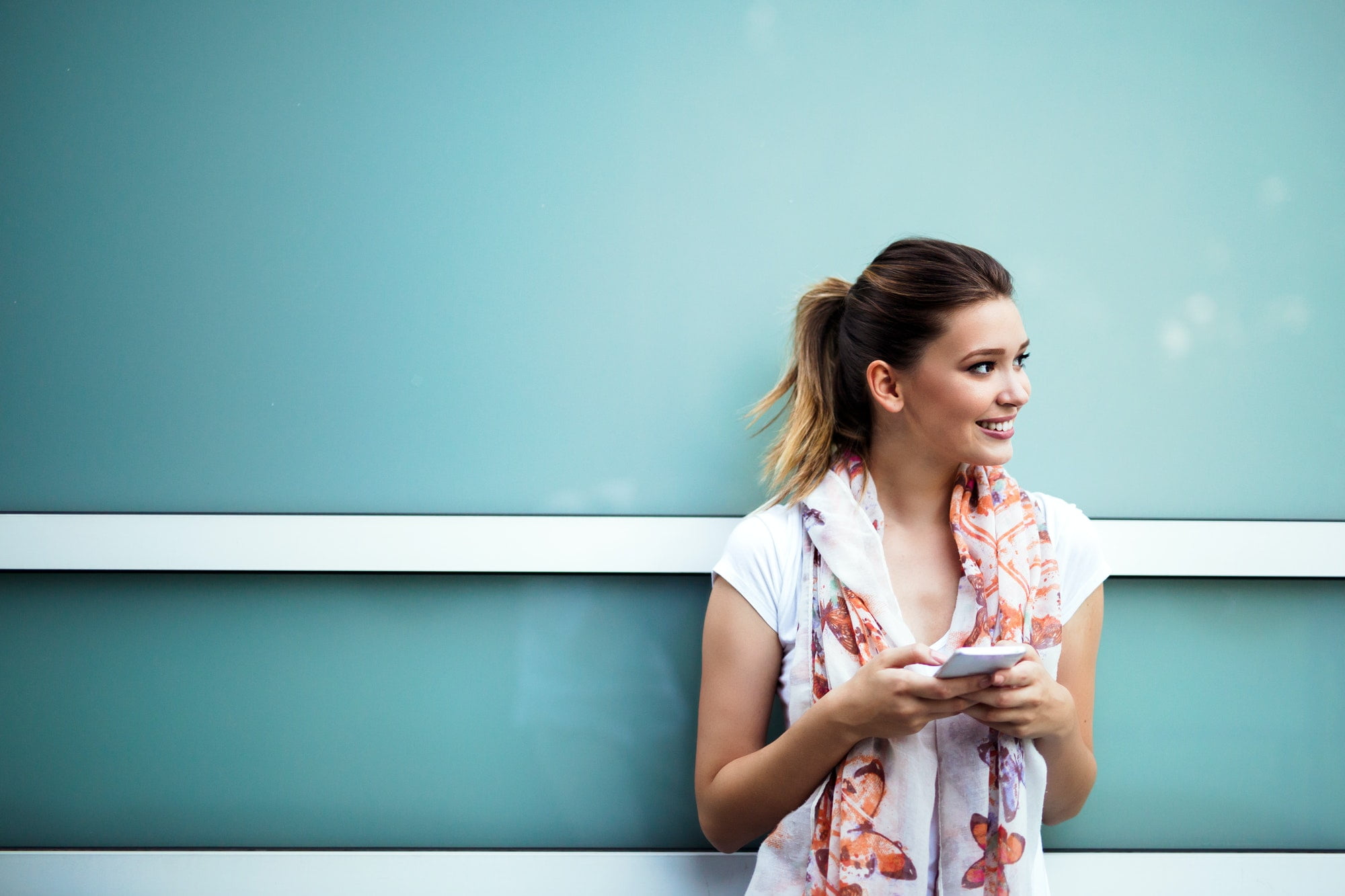 Beautiful woman browsing internet happy in her smart phone