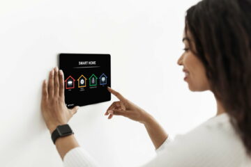 Black lady using smart home device, pushing button on pad