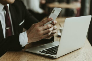 Businessman using a phone and a laptop