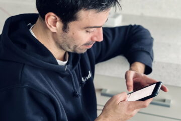 Young man texting from a mobile phone, using mobile devices, chatting, texting, hands chatting