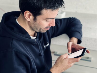 Young man texting from a mobile phone, using mobile devices, chatting, texting, hands chatting