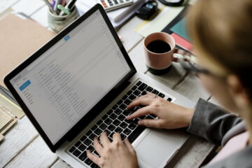 Businesswoman Checking E-mail Online on Laptop