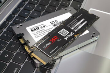 Different types of SSD disk drive isolated on laptop keyboard. Classic SSD and SSD m2.