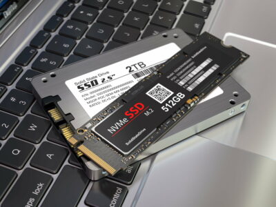 Different types of SSD disk drive isolated on laptop keyboard. Classic SSD and SSD m2.