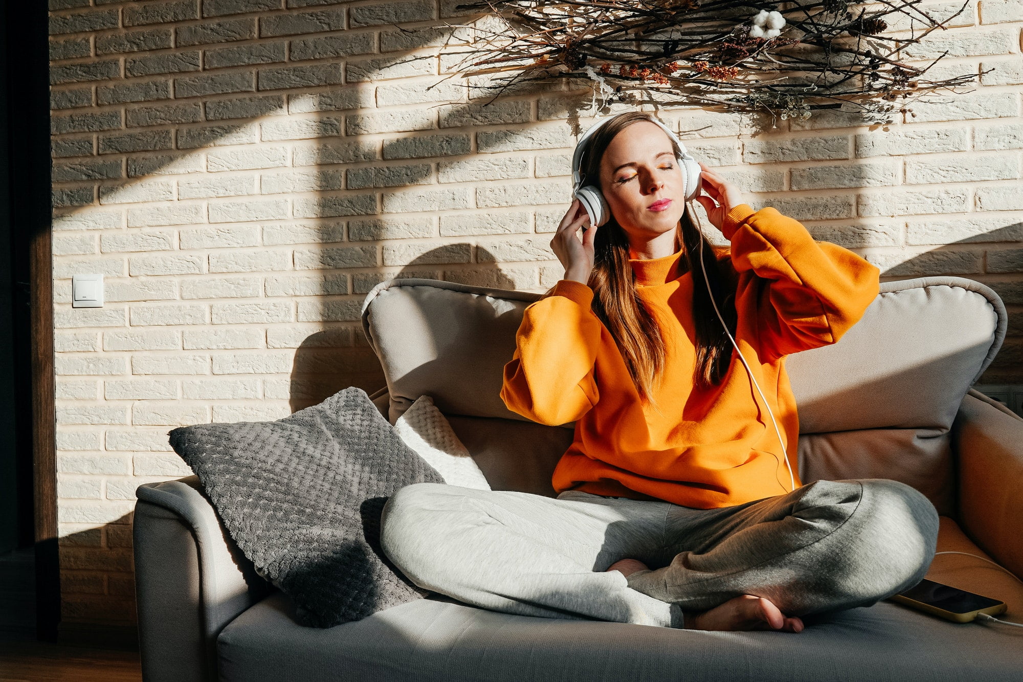 Happy woman listening to music from phone