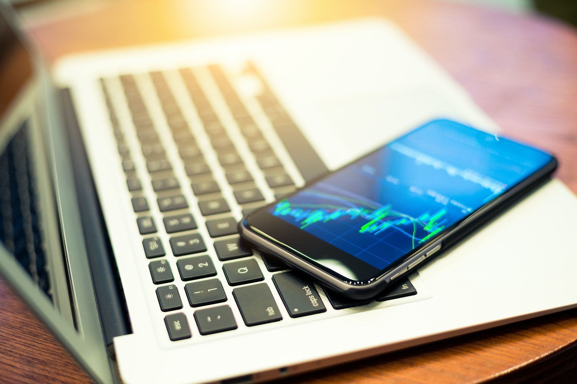 Laptop computer and cellphone with stock market