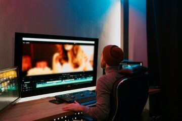 Male Video Editor Working on His Personal Computer with Big Display