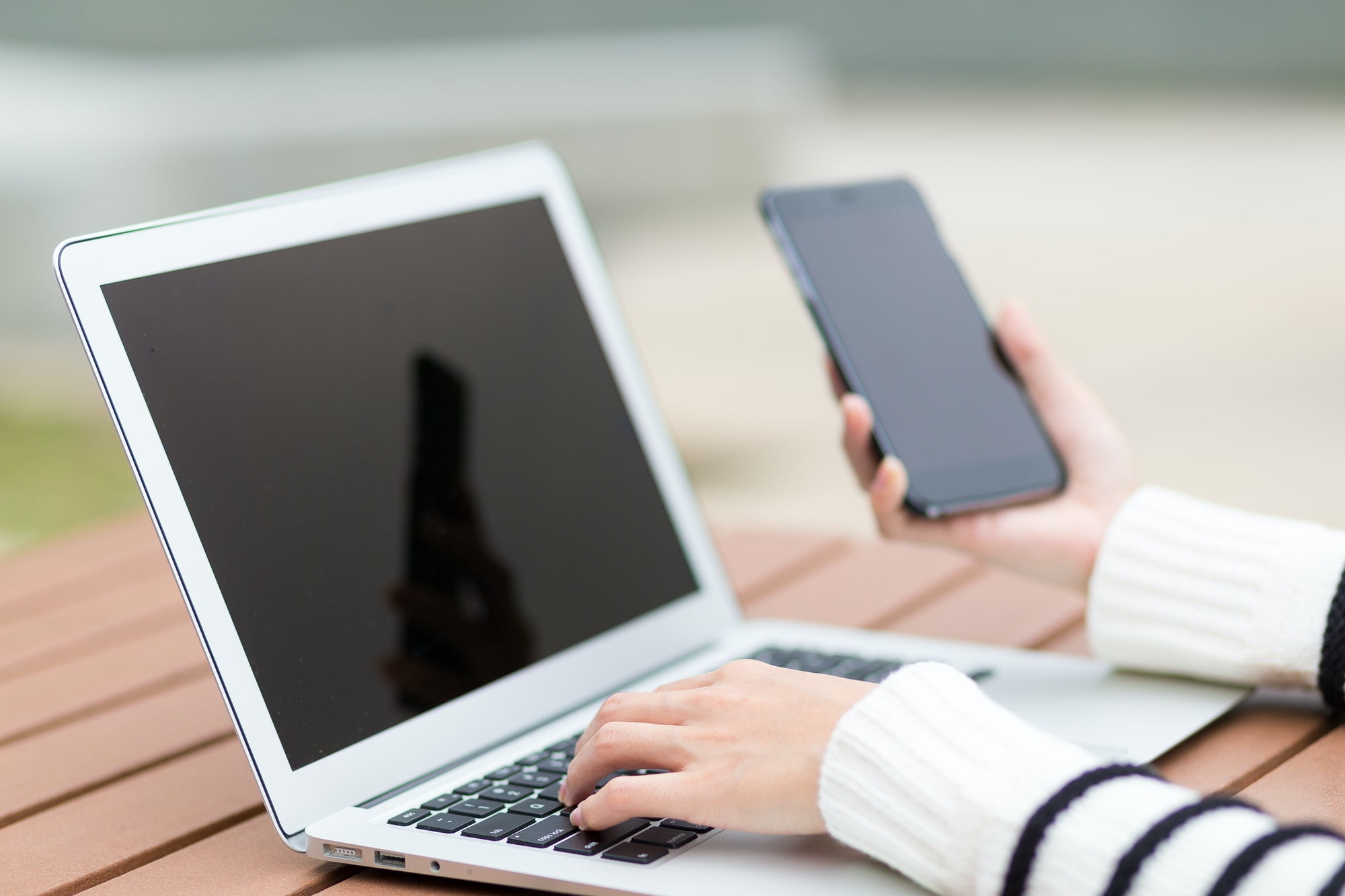 Woman use of laptop computer and cellphone