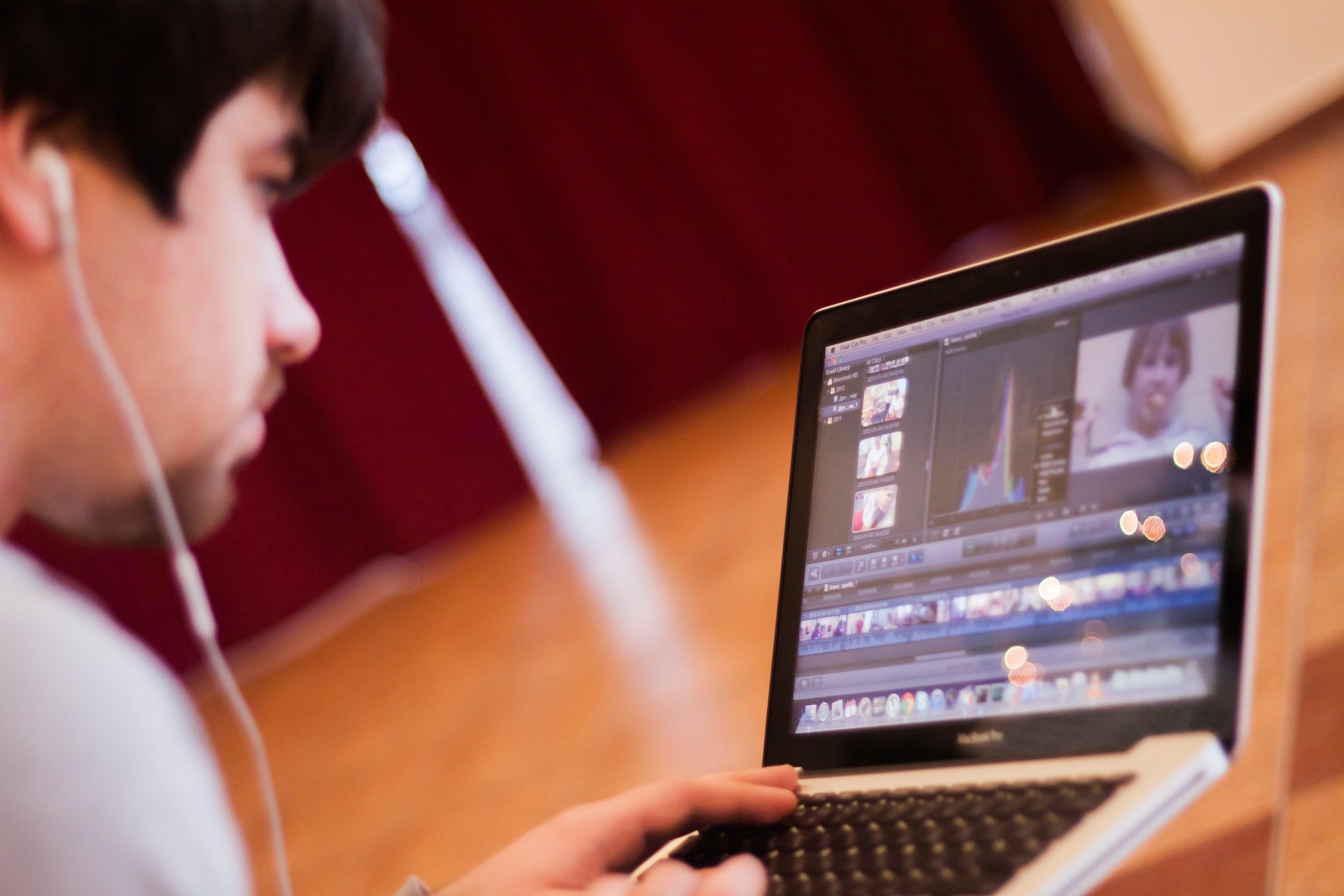 Young guy doing video editing on a MacBook