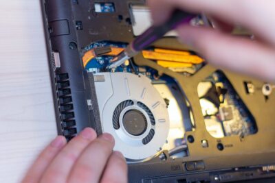 young man hands repare laptop at home