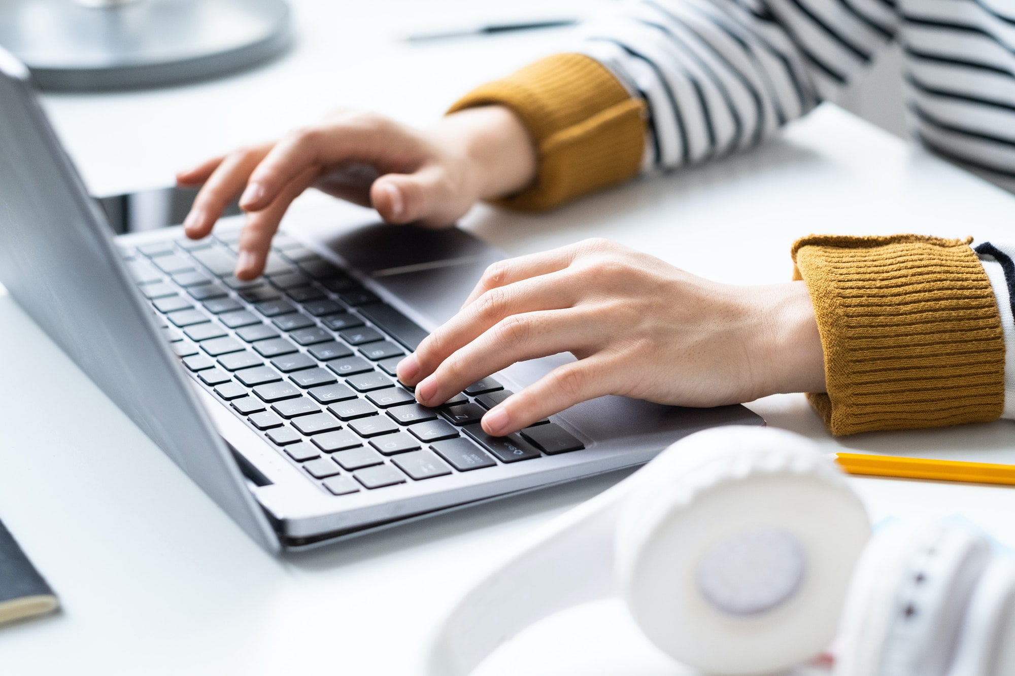 Businesswoman typing on laptop at office