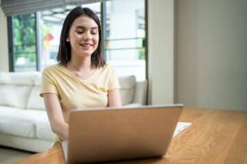 Caucasian beautiful girl study virtual online, watching video at home.