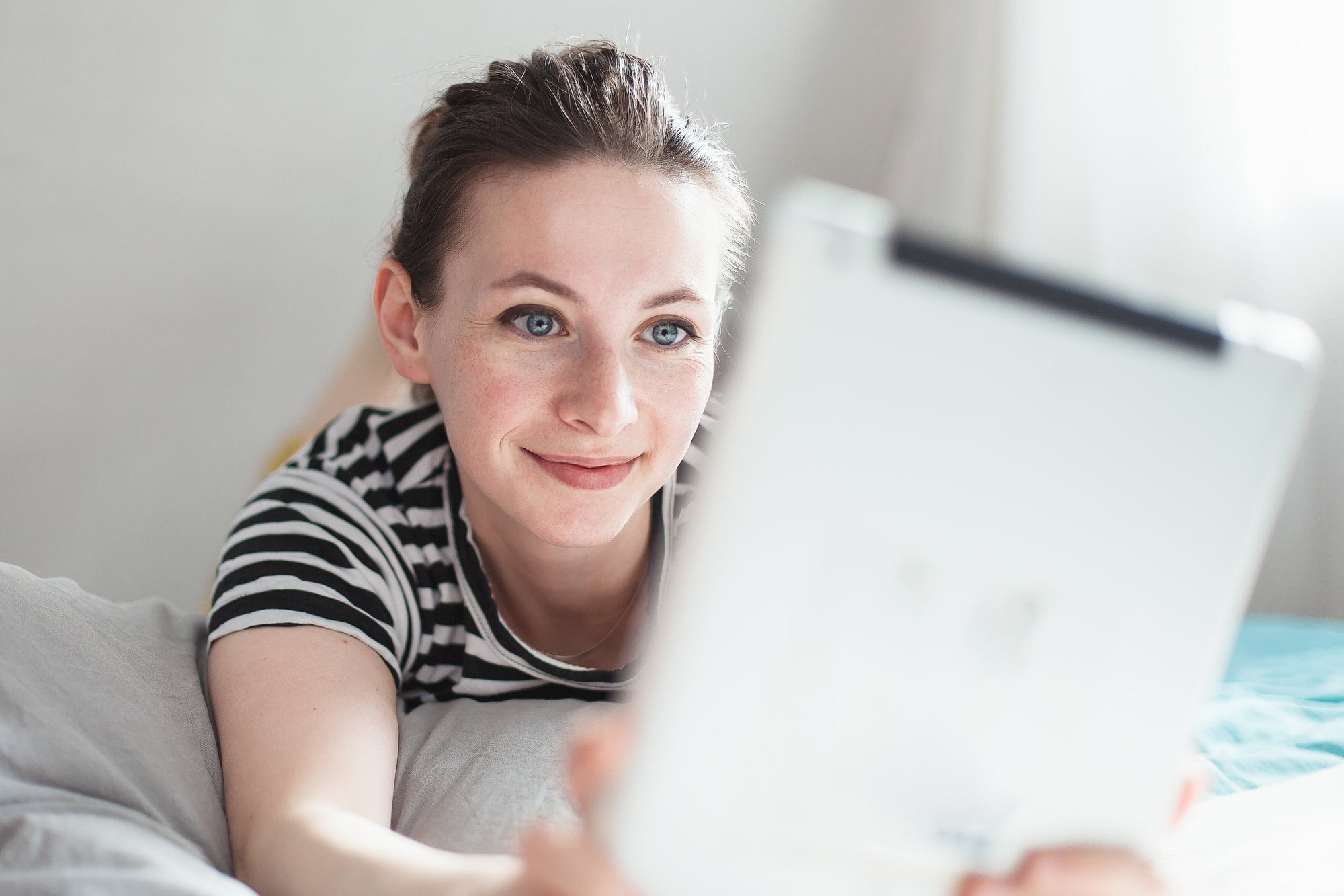 Caucasian woman talking in video chat with her friends, say hello