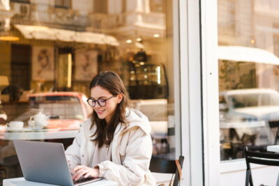 Smiling young woman using laptop