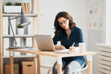 Woman working on a laptop.