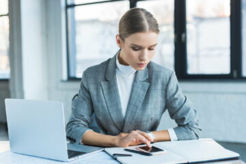 beautiful businesswoman using smartphone in office