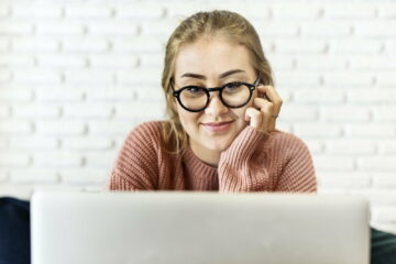 Cheerful young woman using laptop