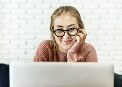 Cheerful young woman using laptop