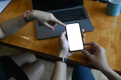 Cropped shot of business people searching for business data online on smart phone.