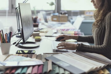 Designer working with her computer in her studio