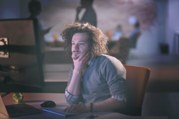 man working on computer in dark office