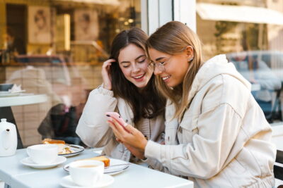 Two young girls using smart phone