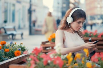 Young girl listening to music outdoors