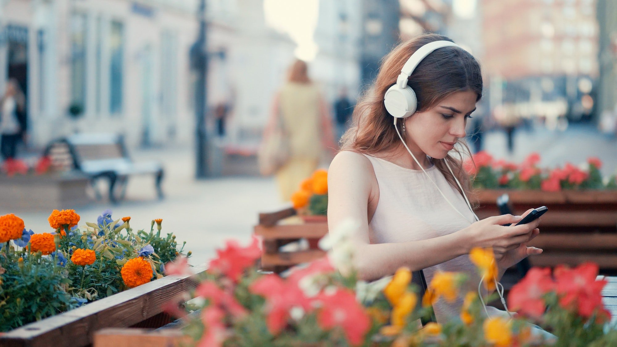 Young girl listening to music outdoors