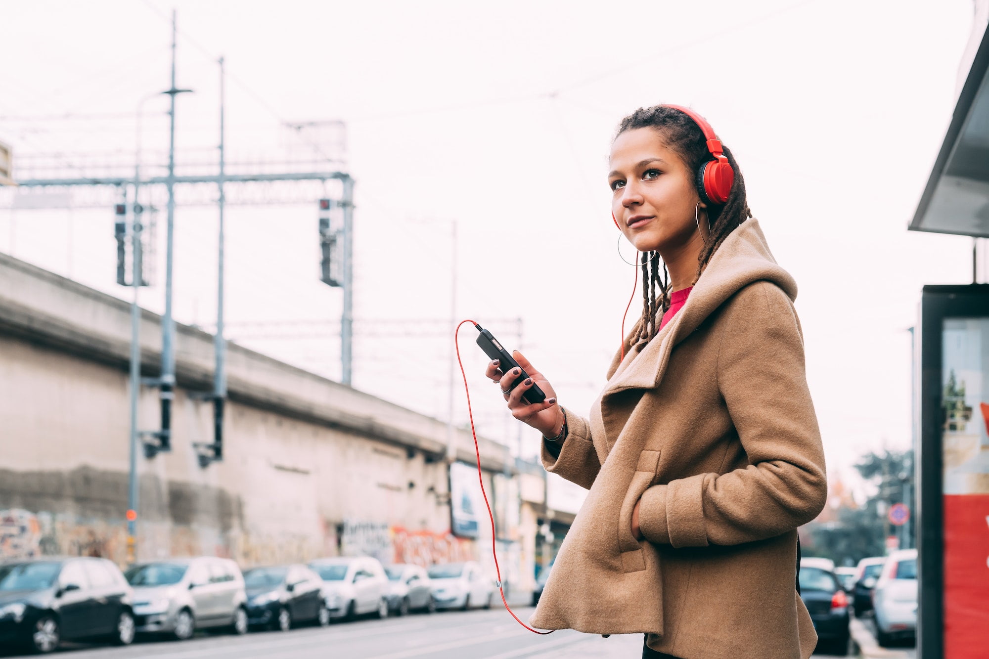 young woman outdoors listening music smart phone