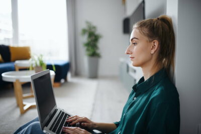 Young woman student with laptop at home, home office and learning