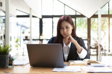 Asian woman working laptop. Business woman busy working on laptop computer at office.