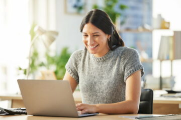 Shot of a young businesswoman working on her laptop at her desk