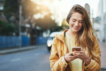 Shot of a young woman using her cellphone while out in the city