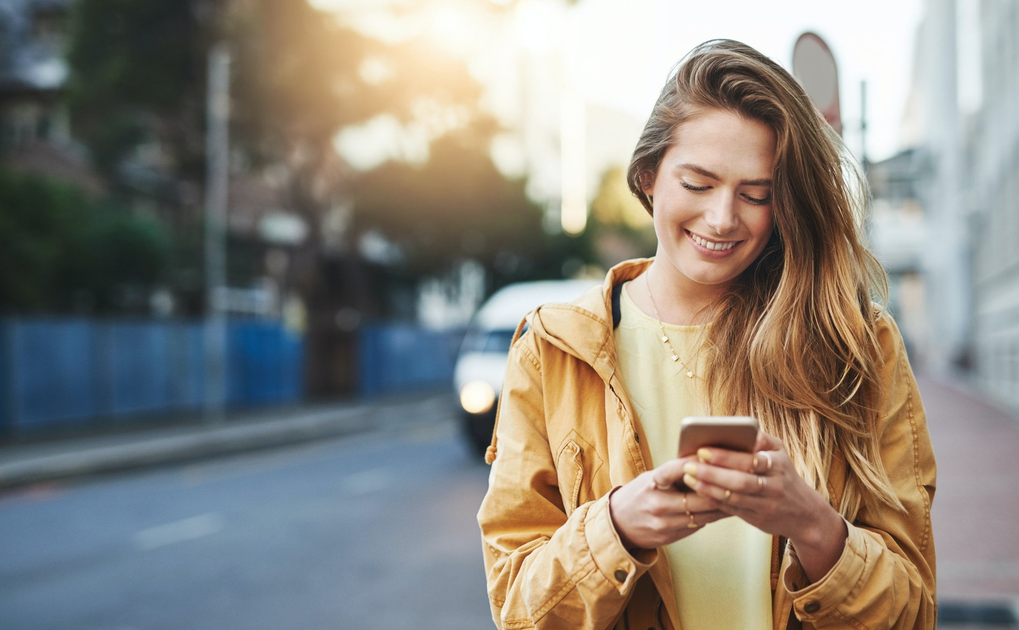 Shot of a young woman using her cellphone while out in the city