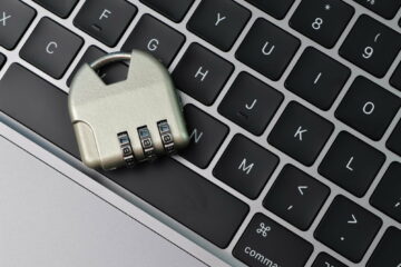 Top view of steel padlock and computer keyboard. Internet security and data protection concept.