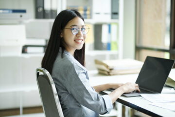 Young asian business woman or student working online on computer laptop.