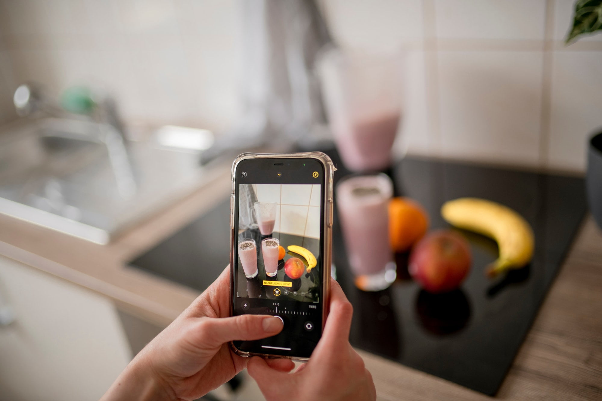 Candid authentic zoomer girl preparing freshly smoothie from fruit ingredients on kitchen at home