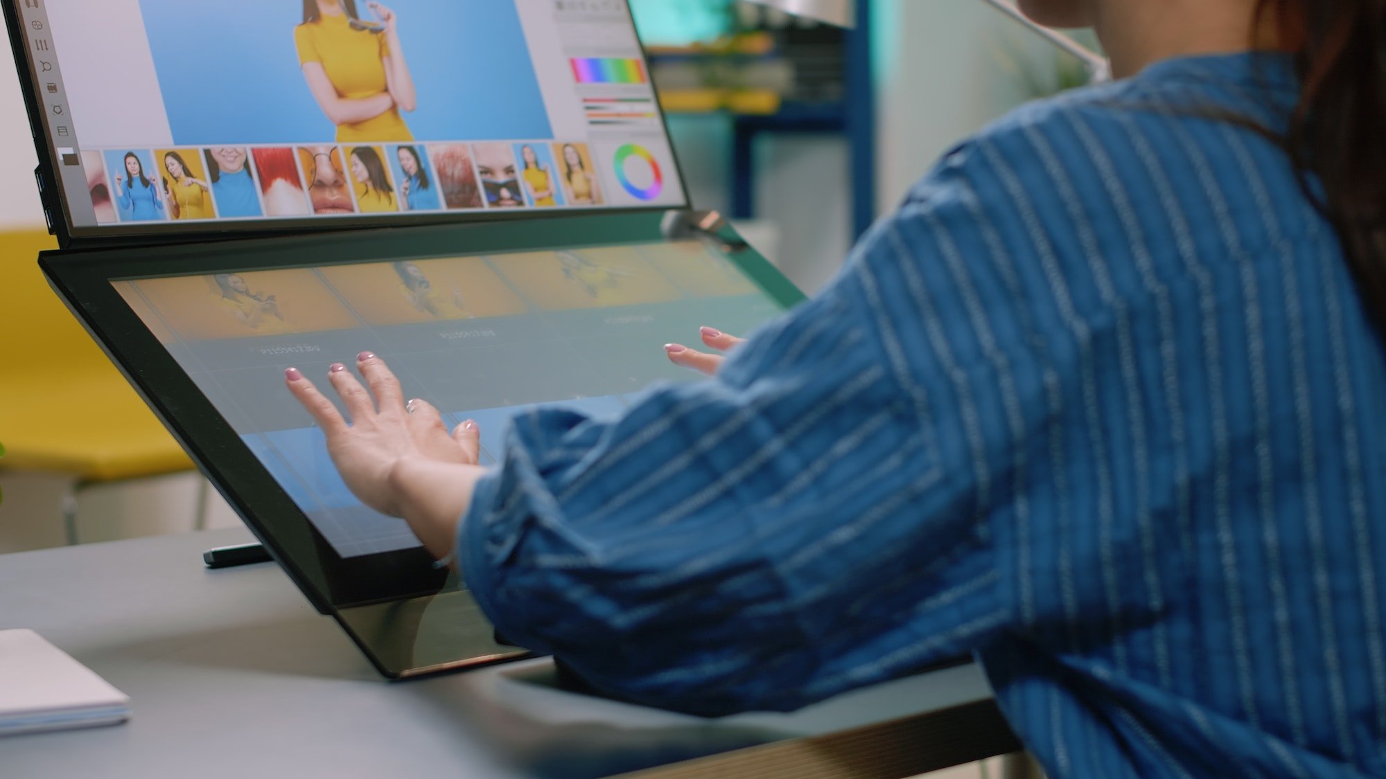 Close up of photographer hands using touch screen monitor