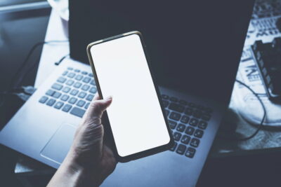 Hand holding an android smart phone in an office