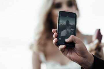 Happy authentic candid married couple in love take selfie for social media outdoor