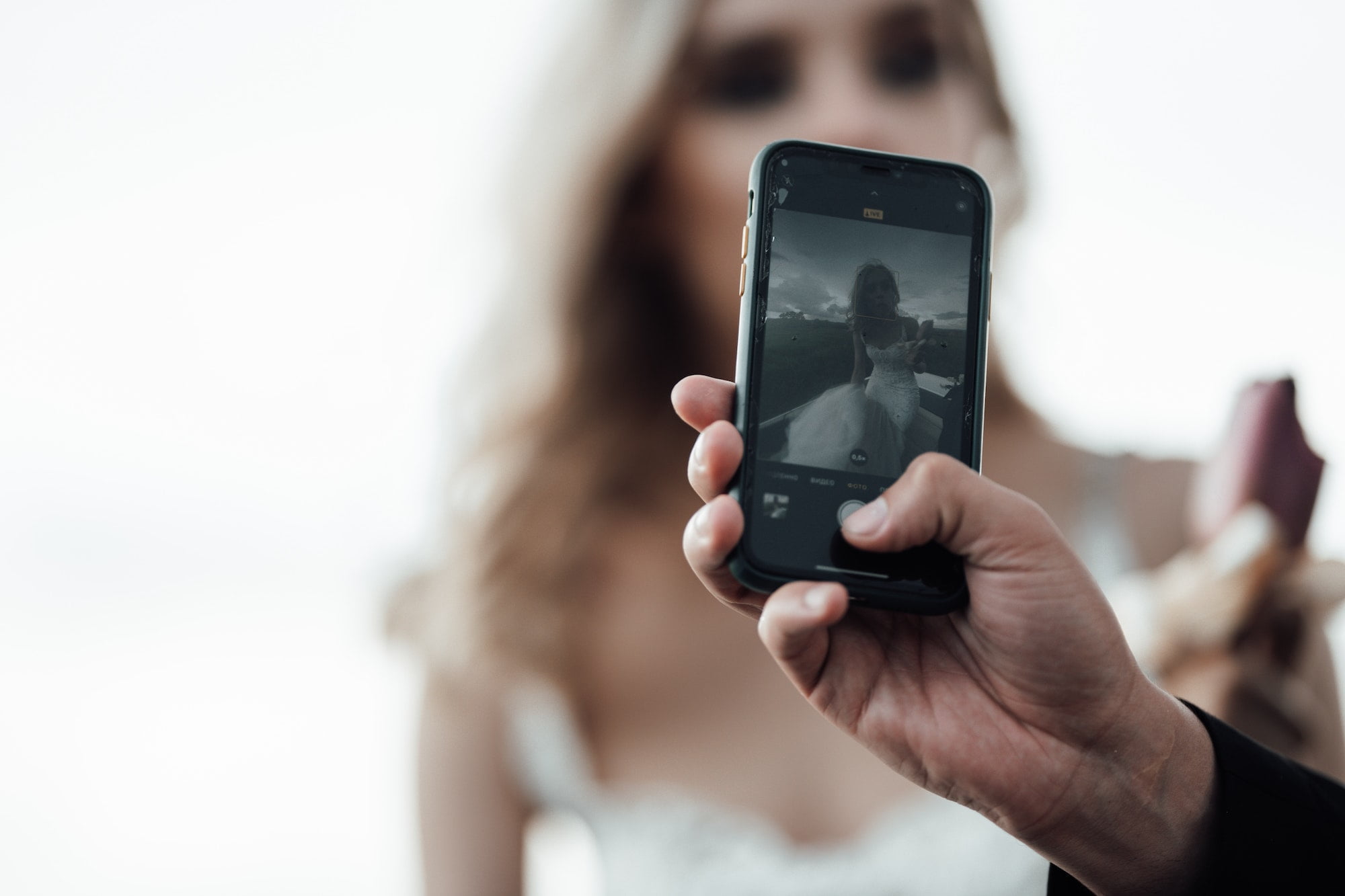 Happy authentic candid married couple in love take selfie for social media outdoor