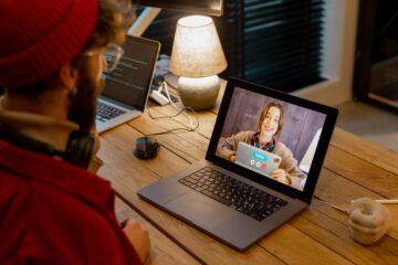 Man having online meeting with female colleague, while work at home