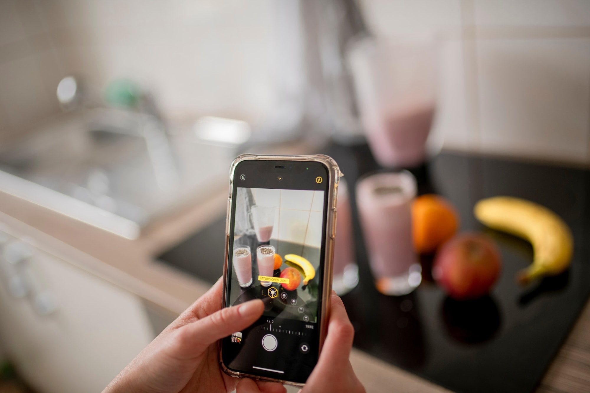 Candid authentic zoomer girl preparing freshly smoothie from fruit ingredients on kitchen at home