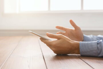 Frustrated man having problem with smartphone, closeup