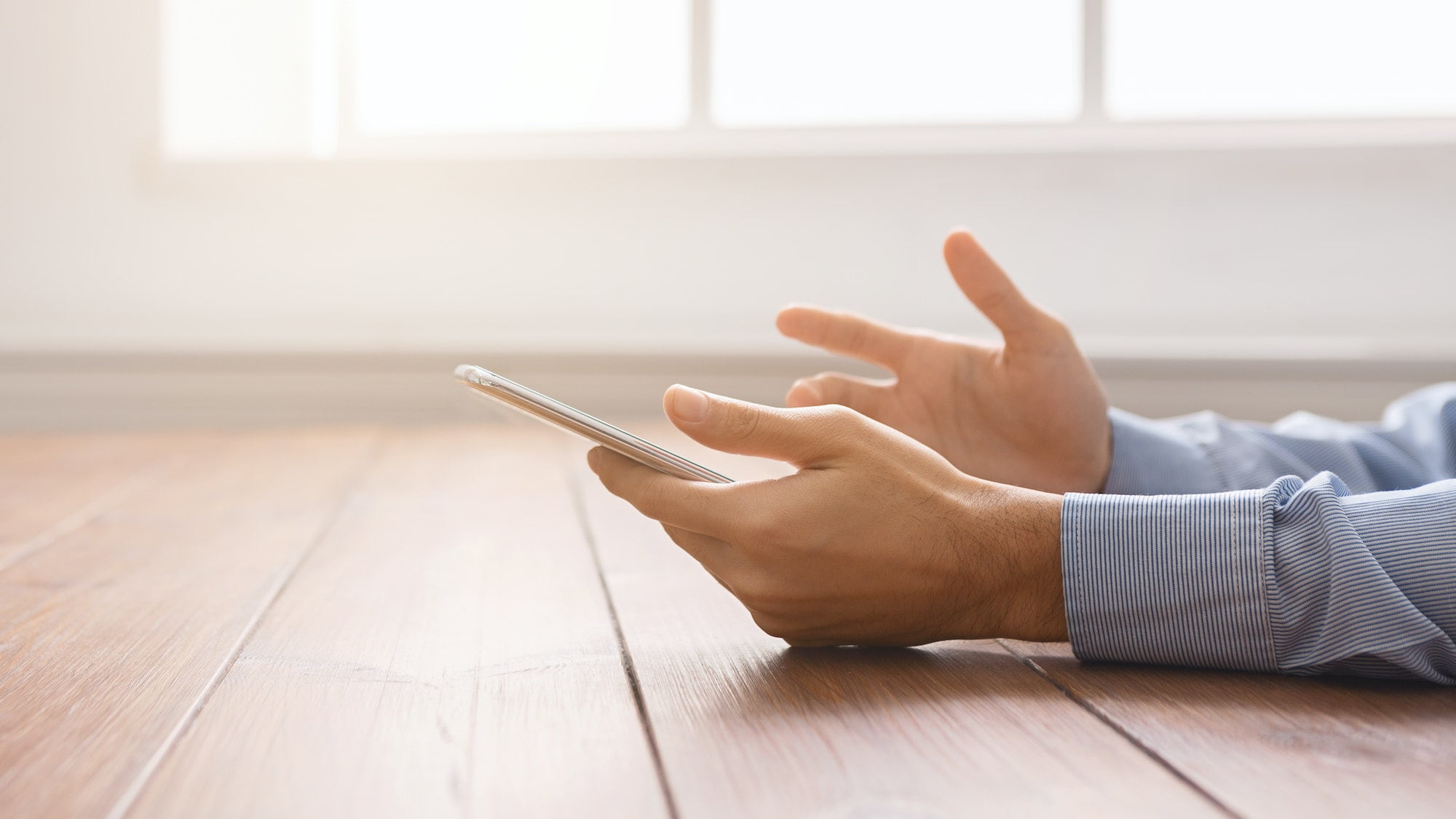 Frustrated man having problem with smartphone, closeup